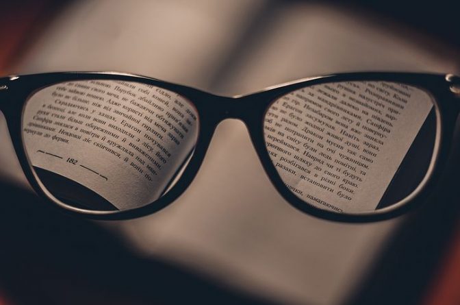 a book and a pair of prescription glasses